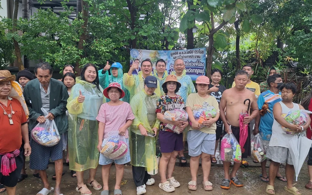 Group of people receiving relief supplies in Kanchanaburi.
