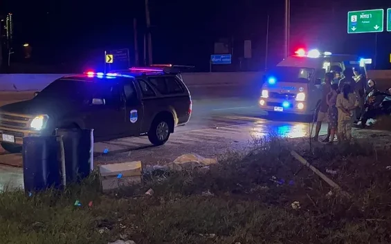 Emergency vehicles at a night time road accident scene.