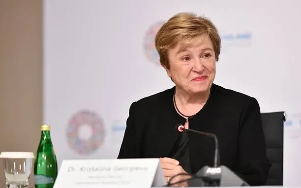 Kristalina Georgieva sitting at a table during a conference.