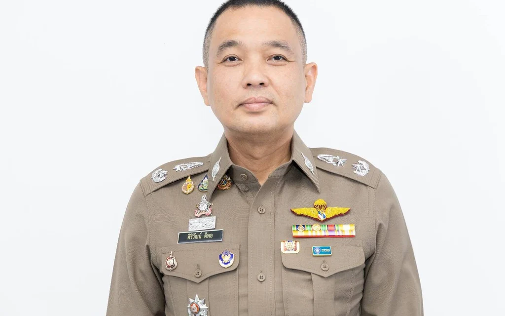 A portrait of a Thai police officer in uniform.