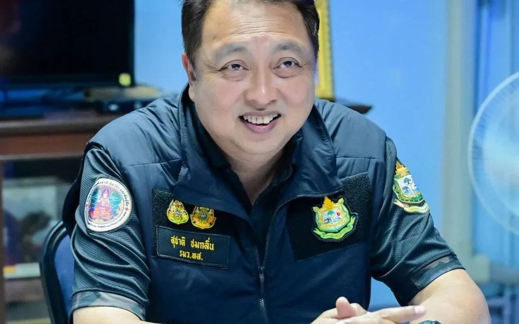 A man in a uniform sitting at a table.