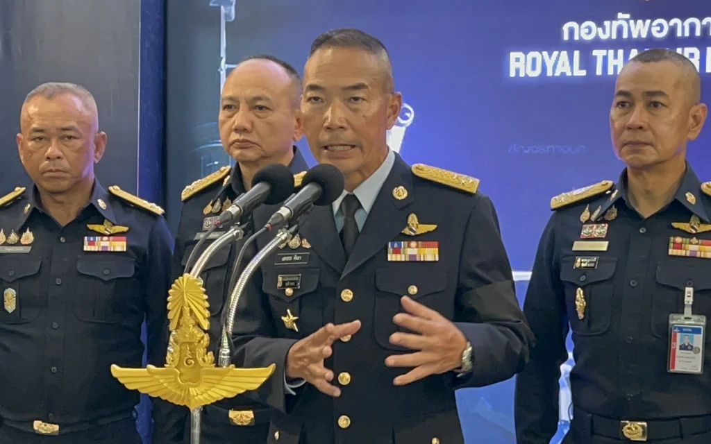 Royal Thai Air Force officers speaking at a press conference.