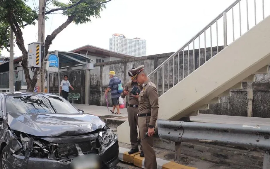Police inspect a badly damaged car after a traffic accident.