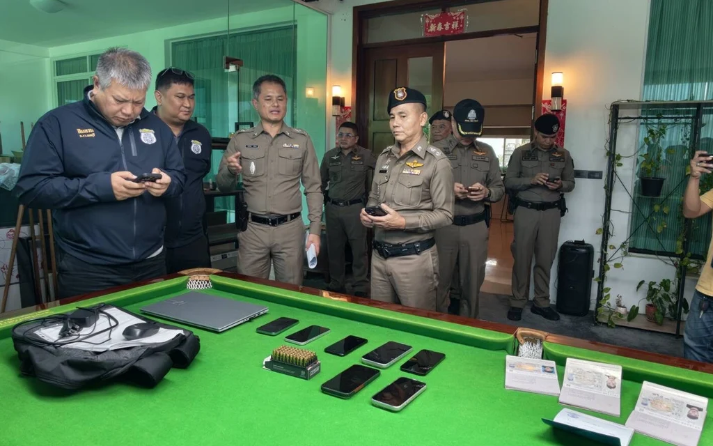 Police display seized phones and equipment during a raid.