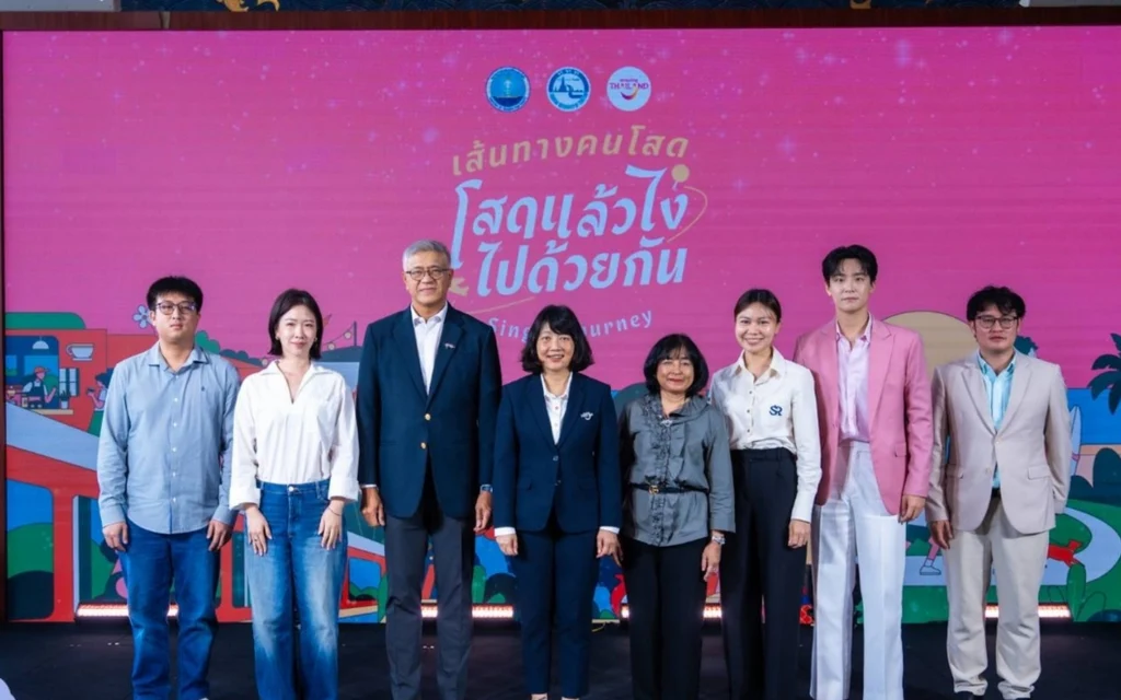 Seven people pose at a tourism project launch event.