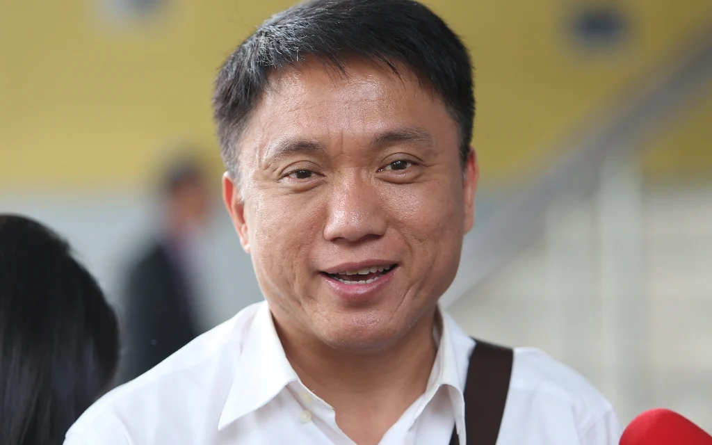 A portrait of Sirichok Sopa speaking to the media.