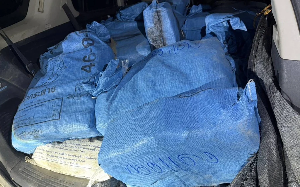 Blue sacks of seized drugs packed inside a vehicle.