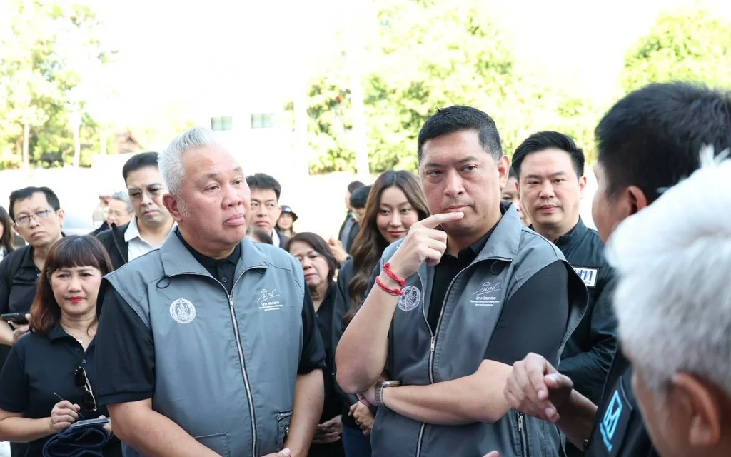 Officials visit a housing project site and speak with attendees.