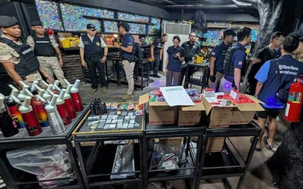 Thai police officers conducting a raid at a nightclub.