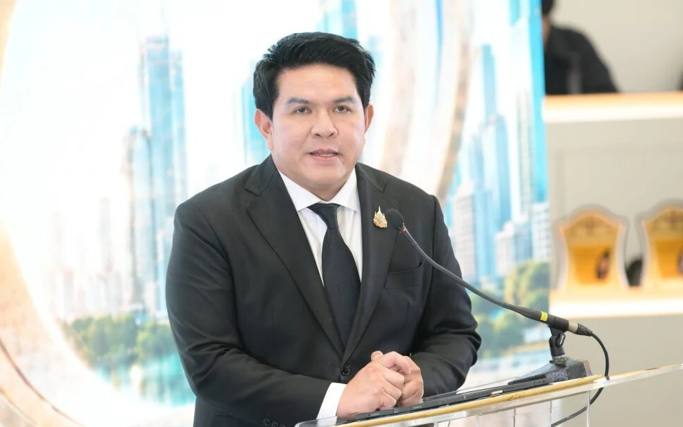A man in a suit speaks at a lectern in a press briefing.