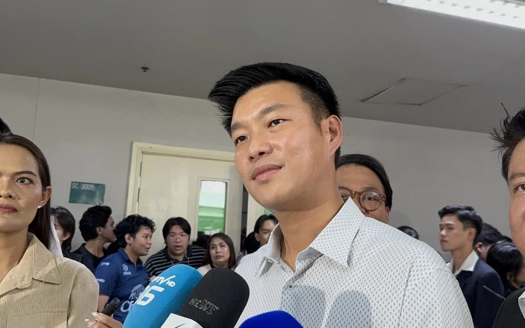 People's Party leader speaks to reporters surrounded by microphones