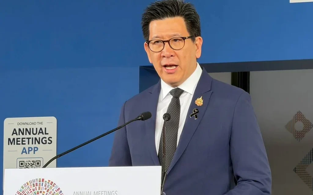 A man speaking at a podium during an annual meeting event.