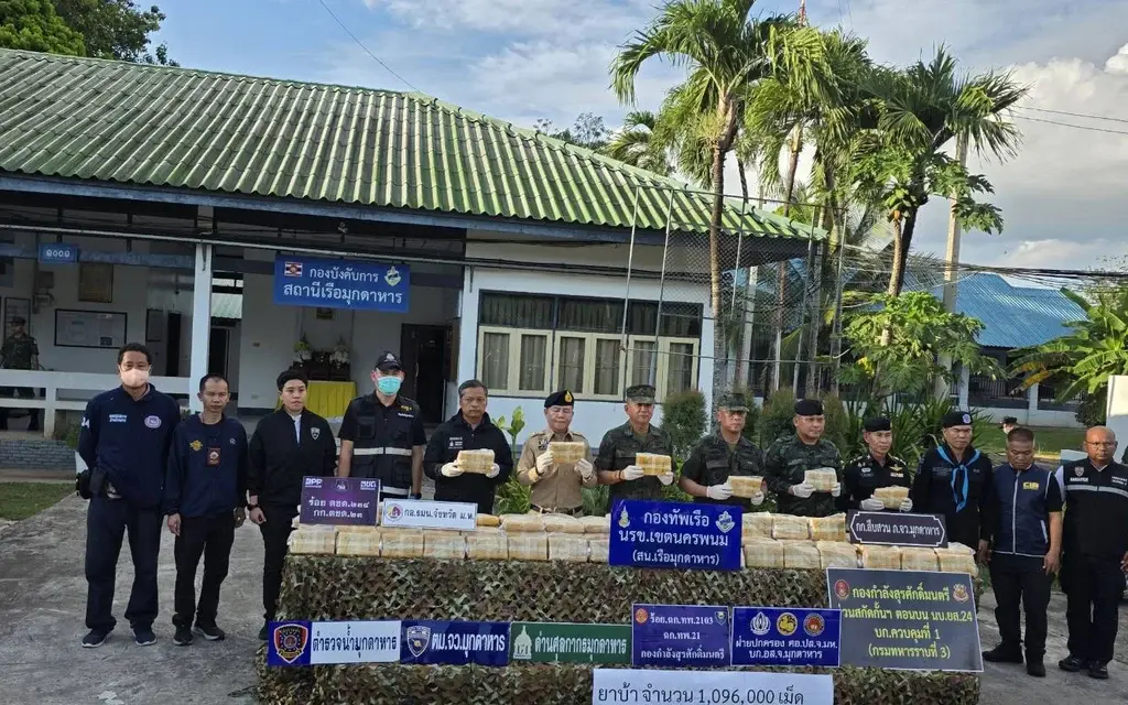 Officials pose behind seized yaba tablets at a Thai customs facility.