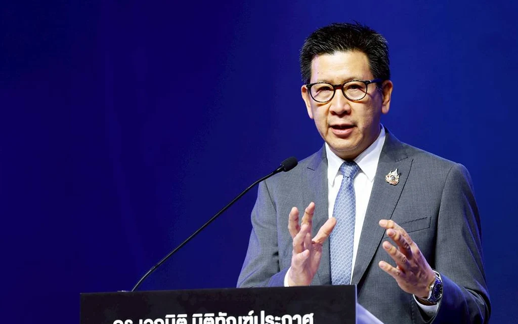Ekniti Nitithanprapas speaking at a podium.