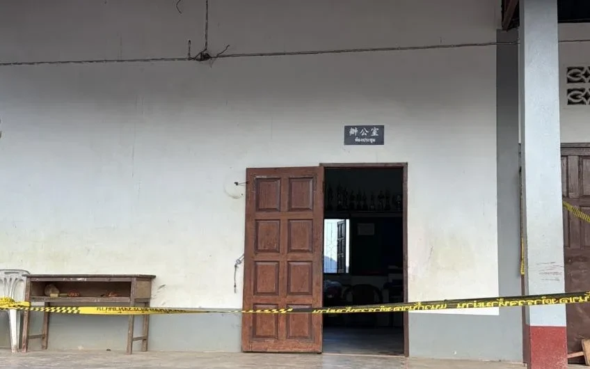 School building entrance cordoned off with police tape after fatal shooting.