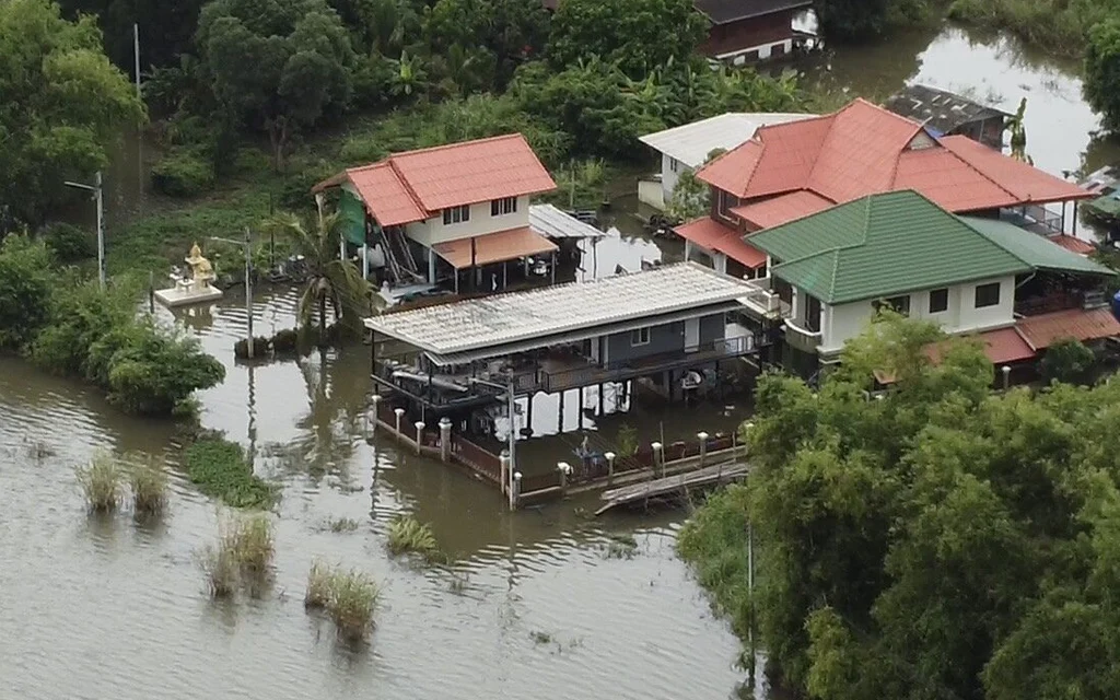 Aerial view of houses surrounded by floodwaters in Thailand.