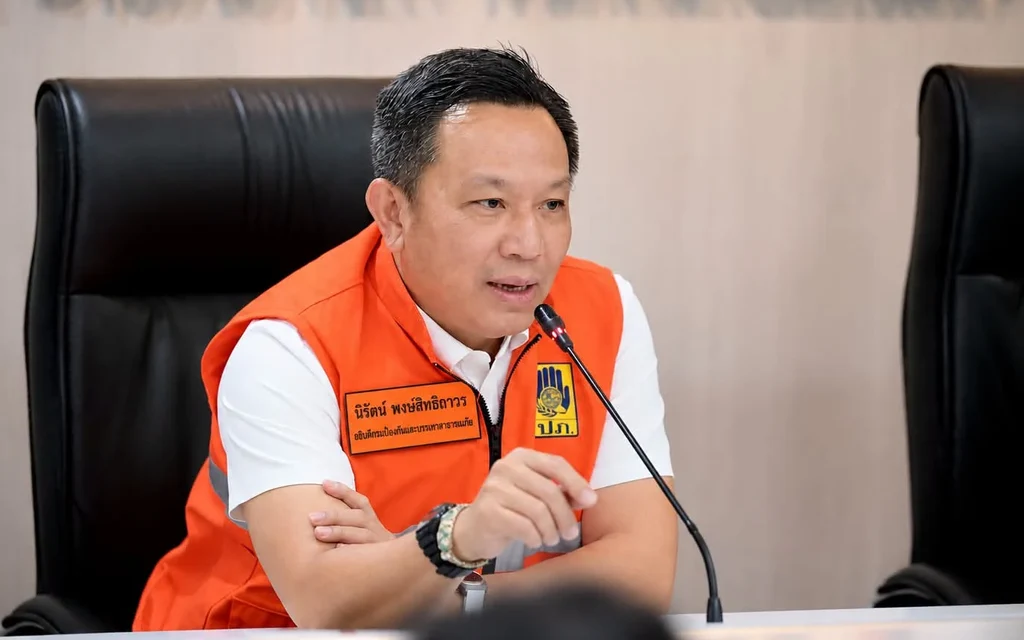 Disaster relief official speaks at a conference table.