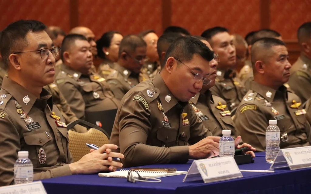 Thai immigration police officers attending a formal meeting.