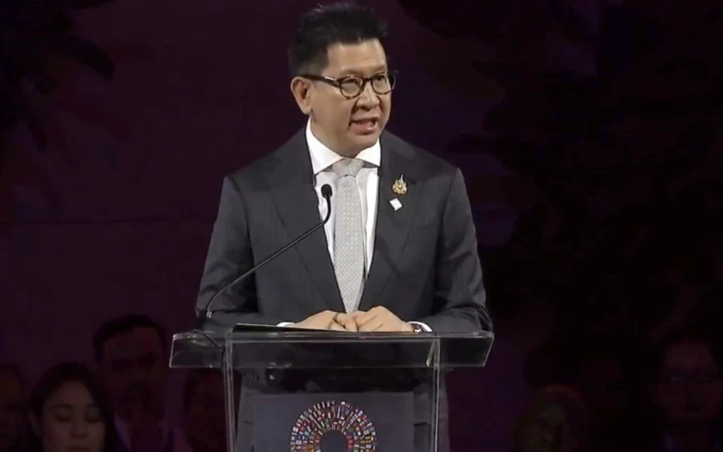 Ekniti Nitithanprapas speaking at a podium at an international conference.