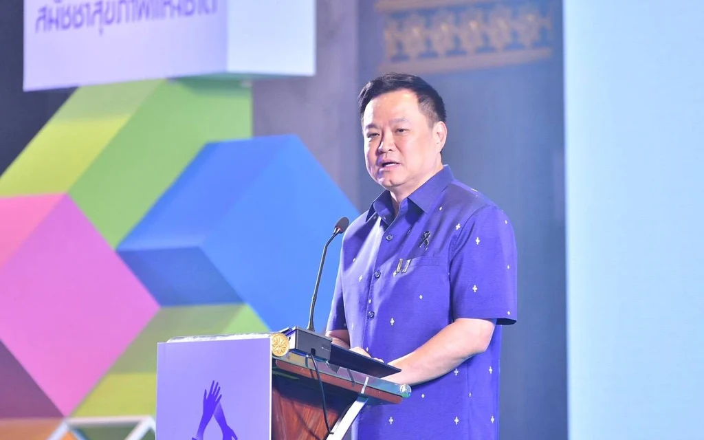 Man speaking at a lectern during a health assembly event.