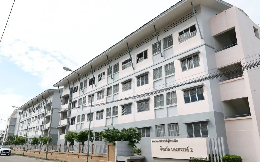 Exterior view of a multi-story housing building in Nakhon Sawan