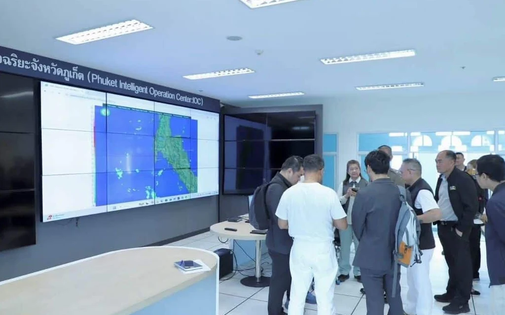 Officials discuss a Phuket tourism safety system in an operations center.