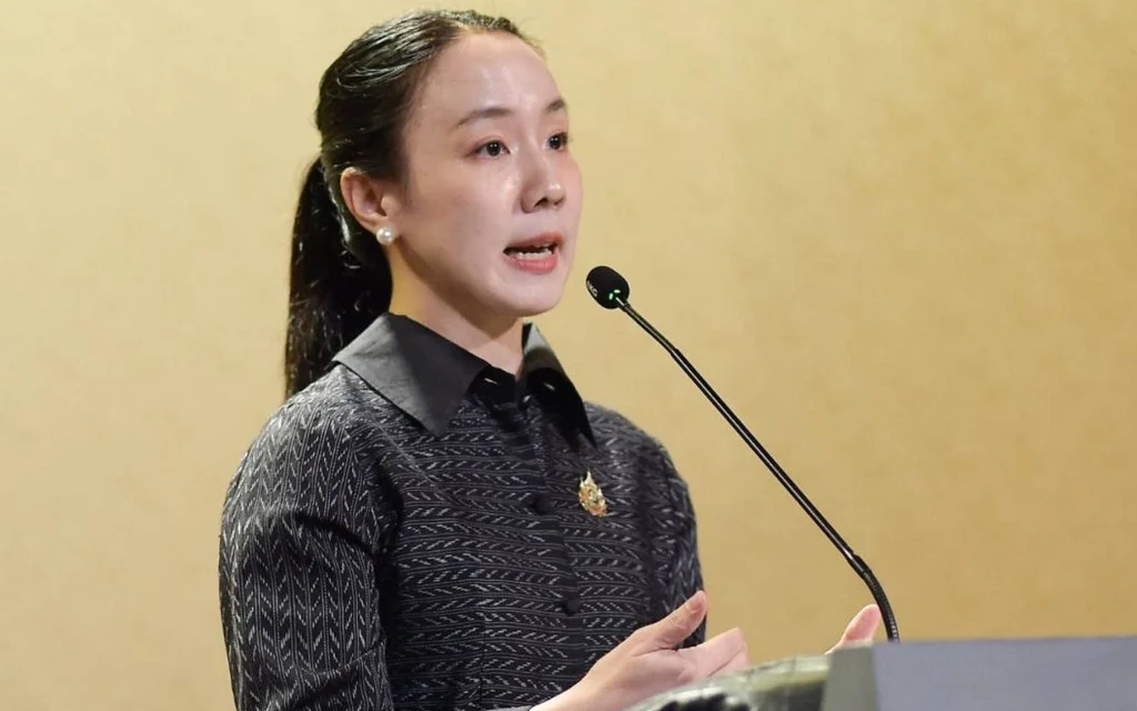 A woman speaks at a podium with a microphone.