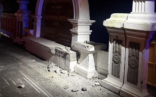 Damaged concrete structure on Thepsrisin Bridge in Phuket at night.