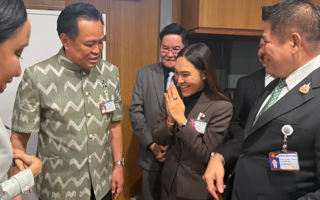 Politicians greet each other at a gathering inside Parliament.