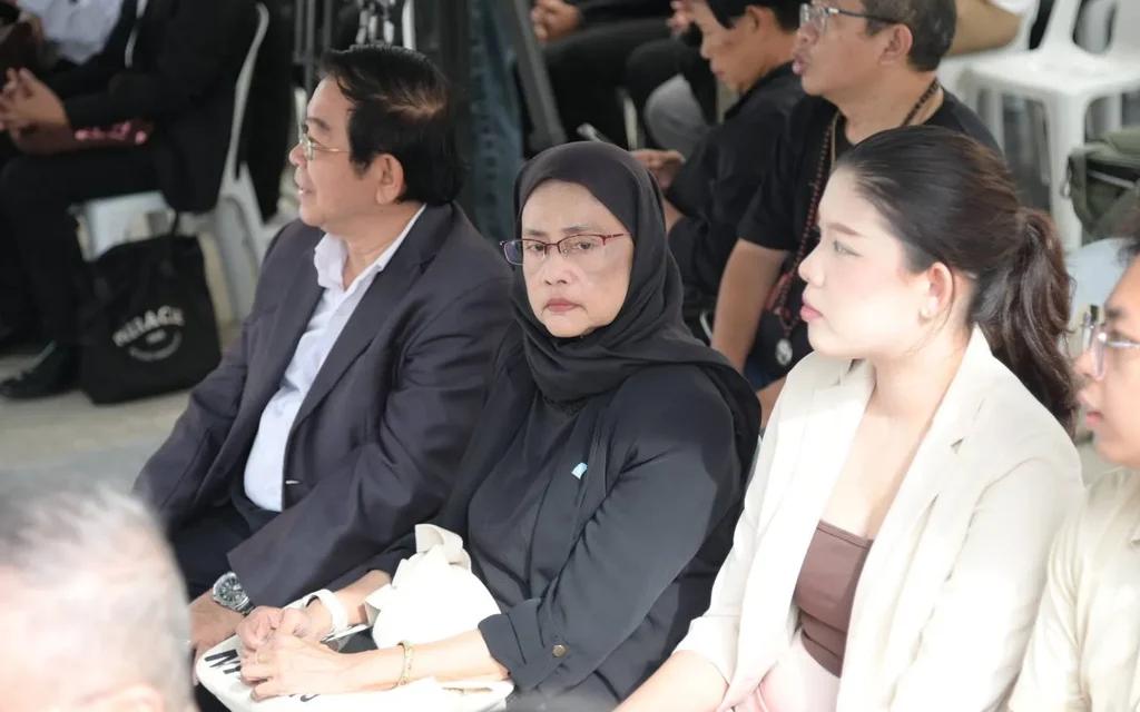 People sitting in an audience at an event.