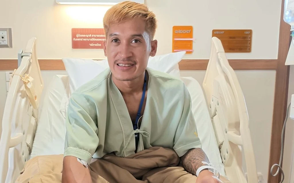 Football captain sitting in a hospital bed after an on-field collision.