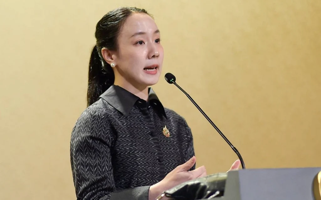 Woman speaking at a podium with a microphone