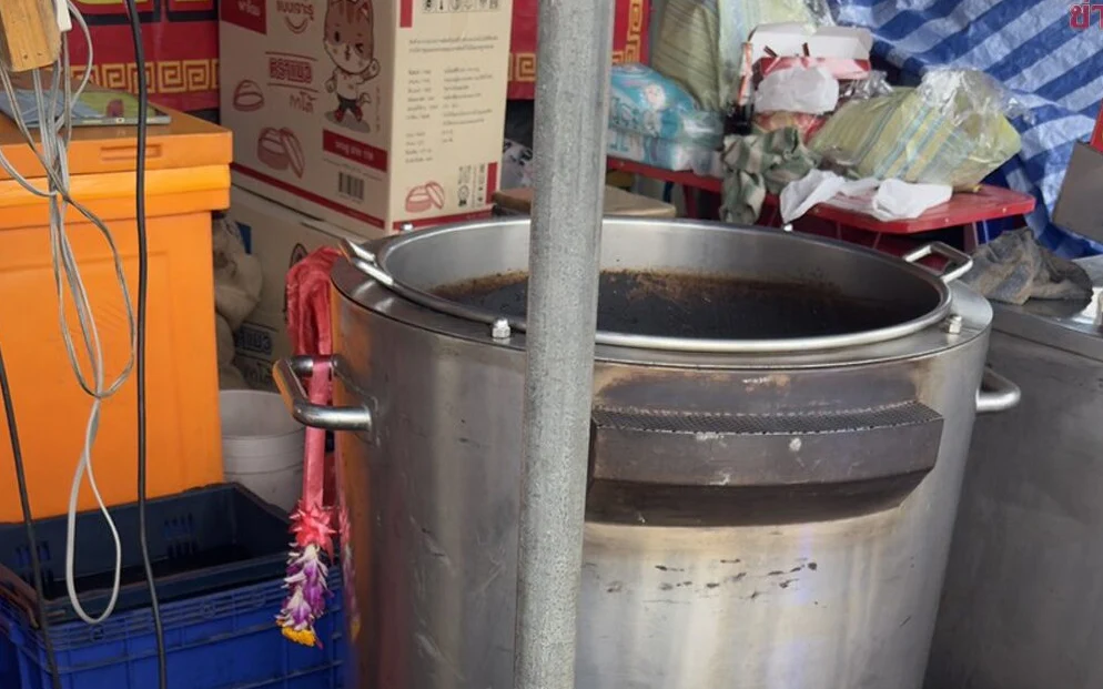Large metal cooking pot at a food stall