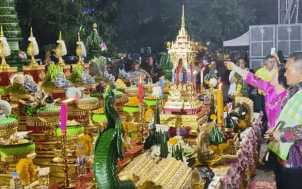 Officials and attendees view elaborate offerings at a festival ceremony.