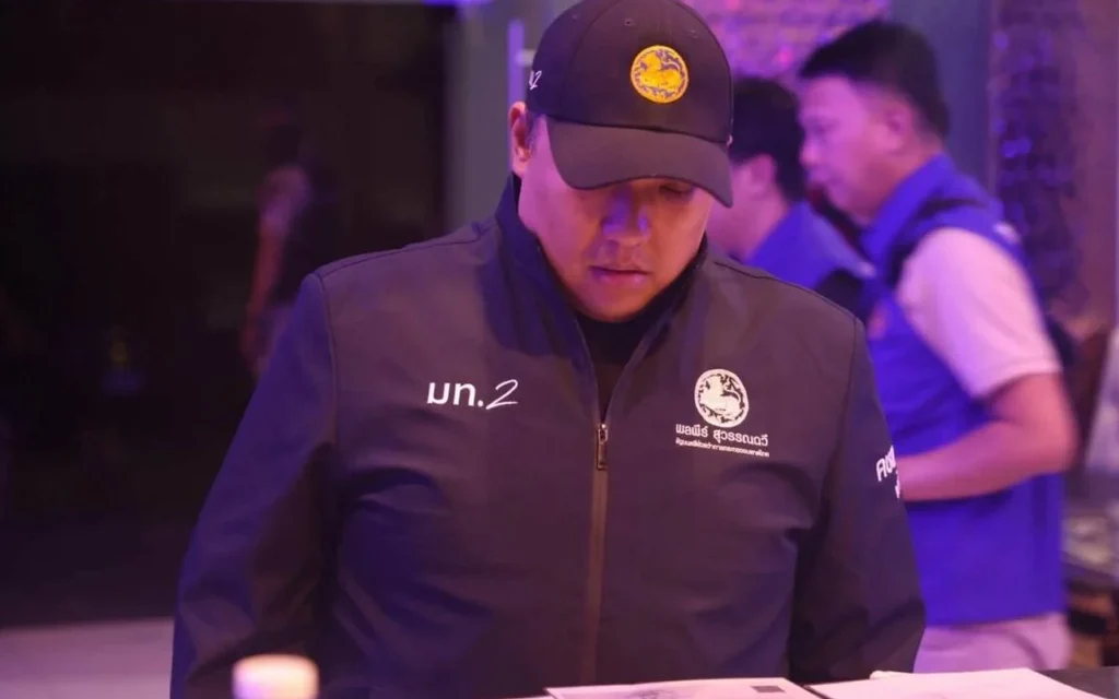 Interior ministry official examines paperwork during a venue raid.