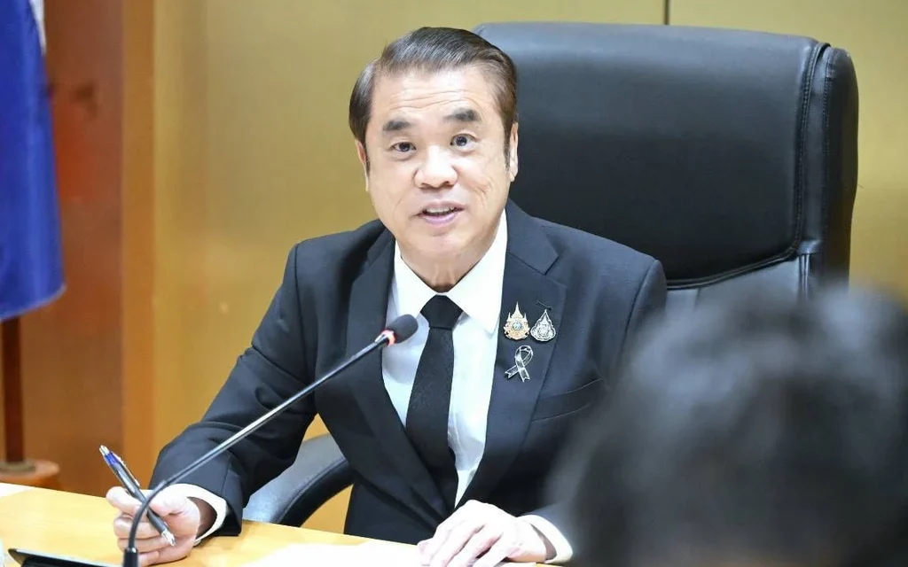 Thai politician Suriya Juangroongruangkit sitting at a meeting table.