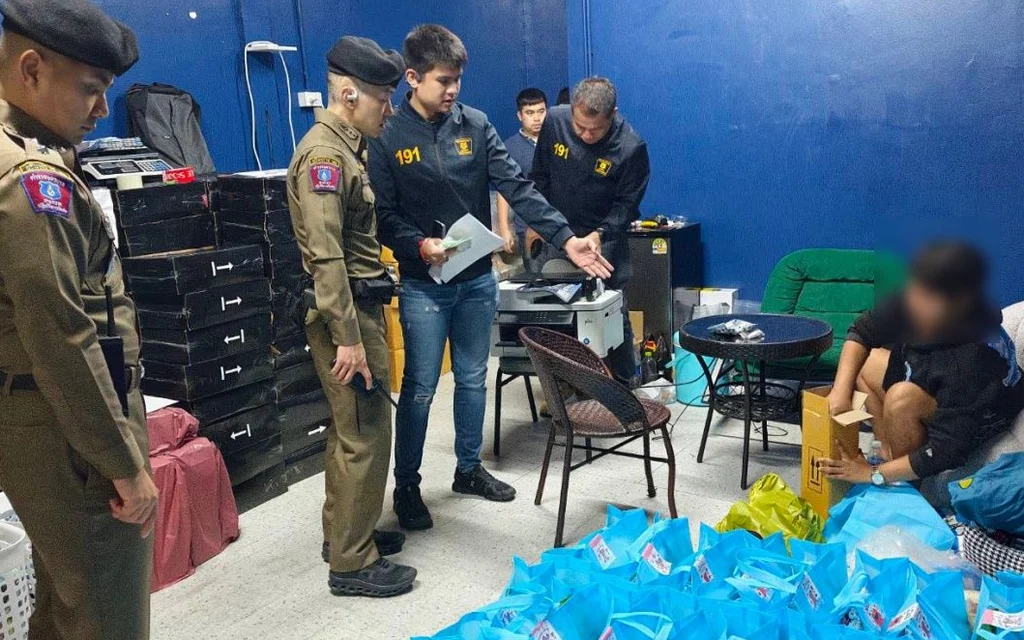 Police and investigators examining evidence with a seated blurred suspect