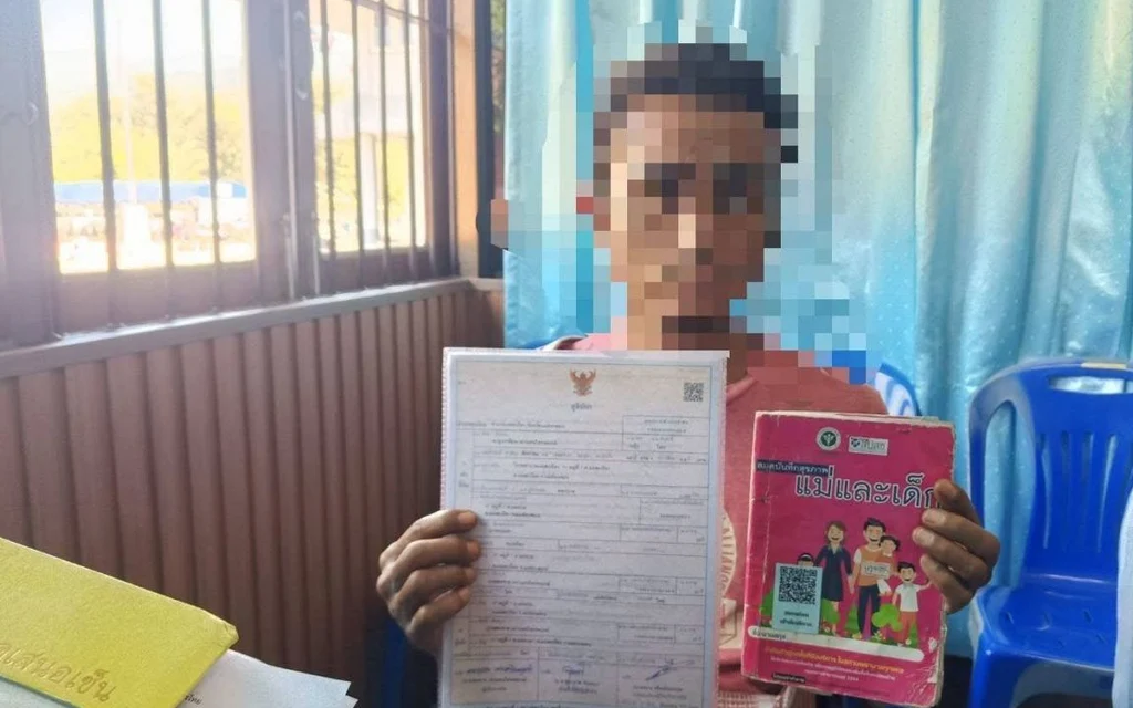 Pixelated man holding birth certificate and pink booklet indoors