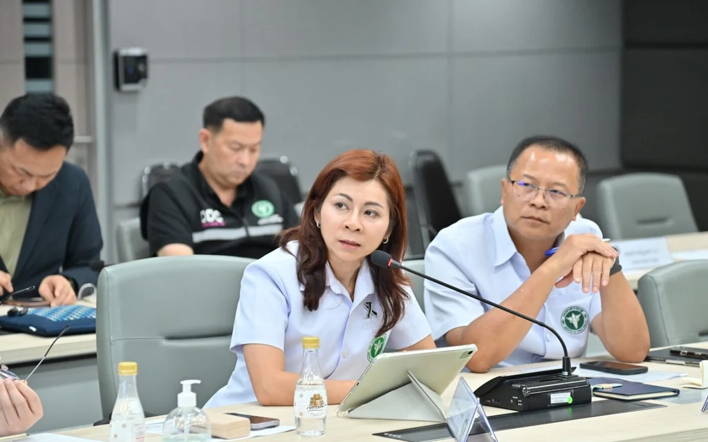 A group of officials attending a meeting in a conference room.