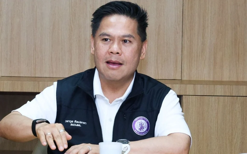 Warawut Silpa-archa sitting at a table during a meeting.