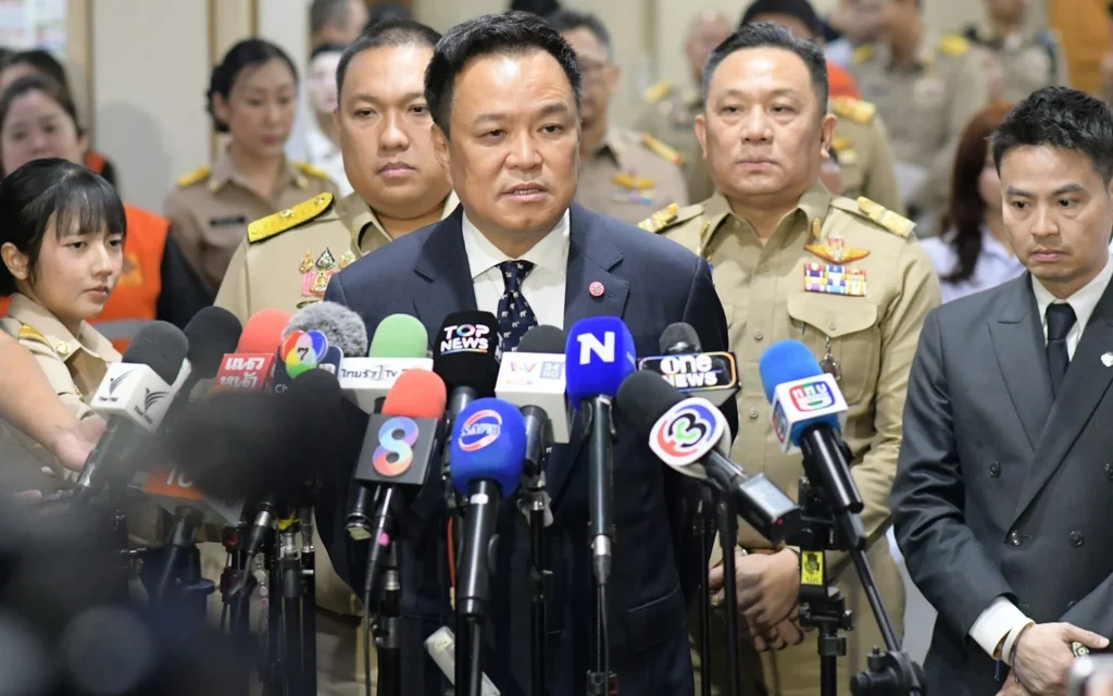 Anutin Charnvirakul speaking to reporters at a press conference.