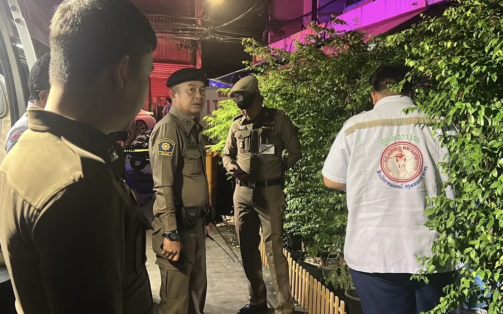 Police officers investigating at night.