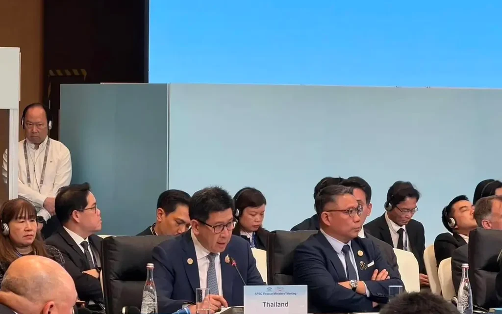 Officials attend an APEC meeting, with a Thailand nameplate at the table.