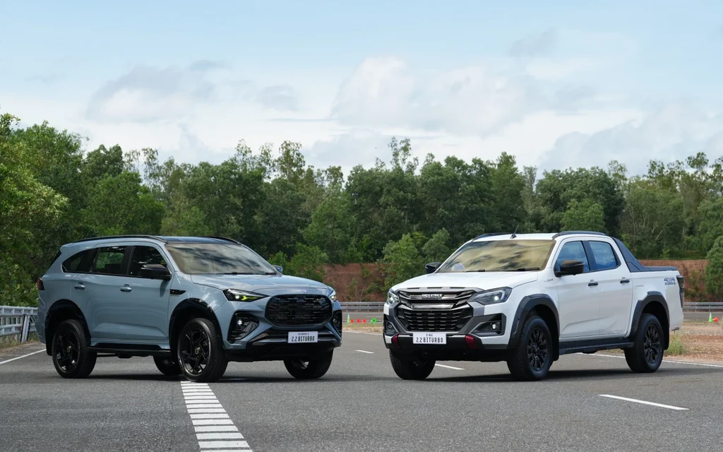 Two pickup trucks displayed on a paved test track.