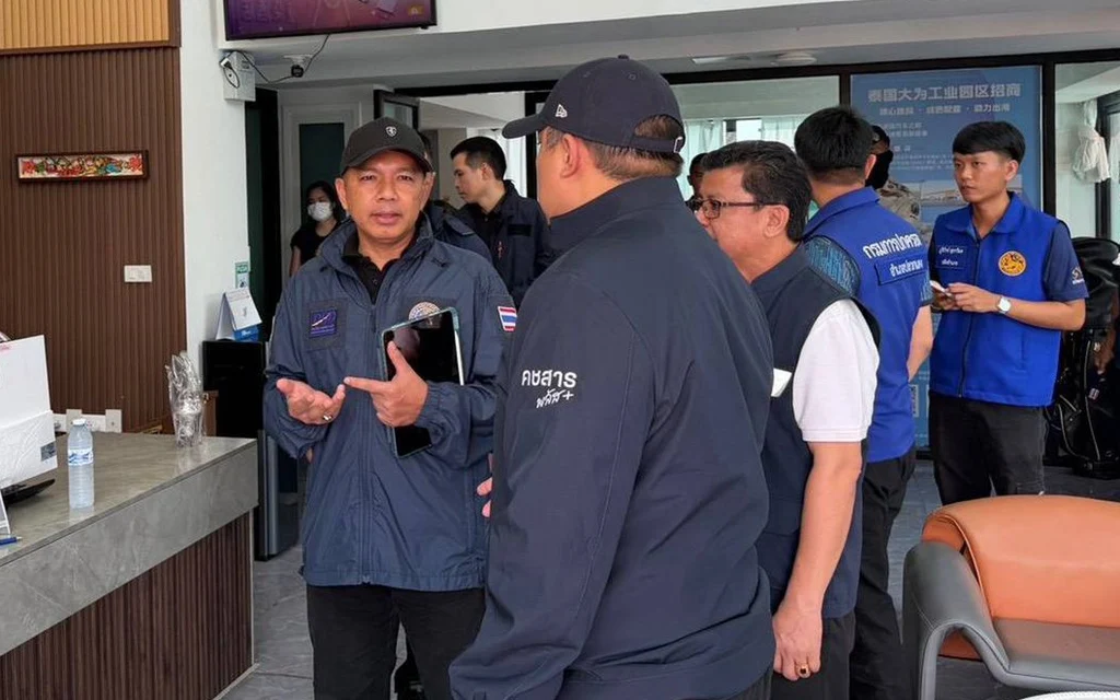 Officials inspect a business premises in Rayong.