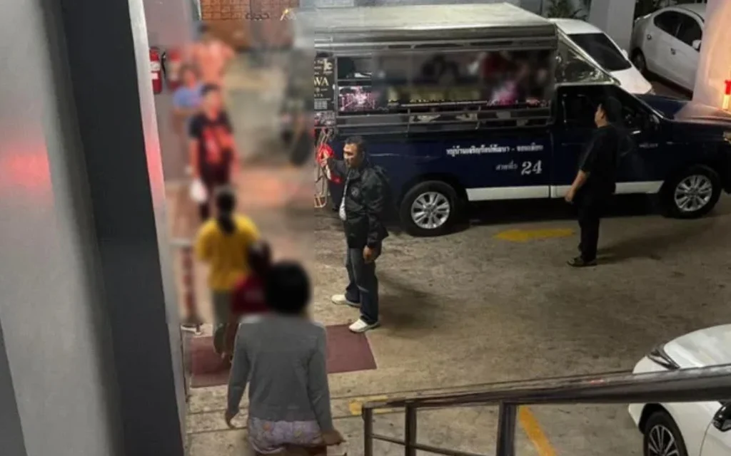 People walking near a police vehicle in a parking area.