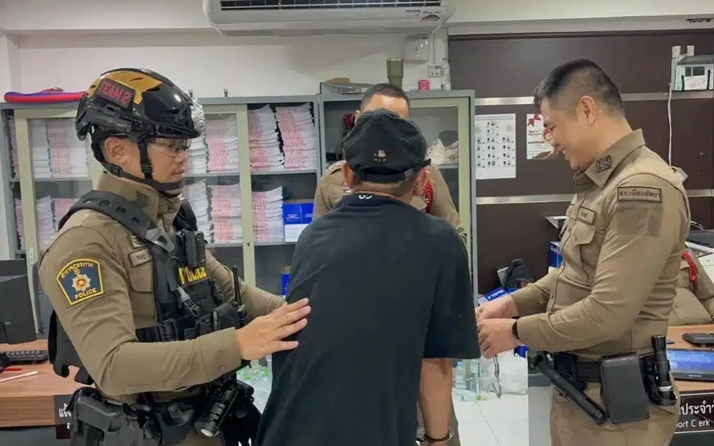 Police officers detaining a suspect inside an office with filing cabinets in background