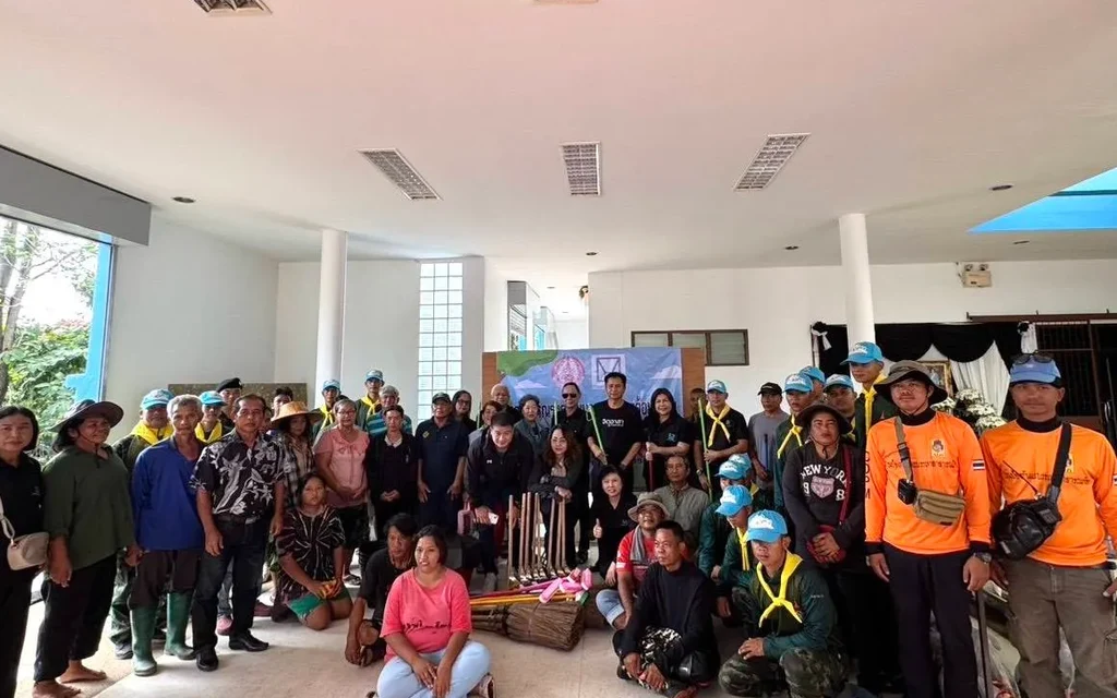 Community volunteers pose together inside a flood-hit housing project.