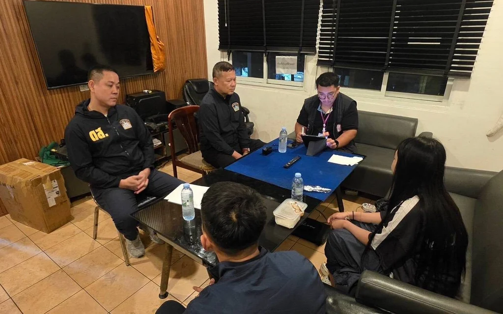 Police officers interviewing a person in an office
