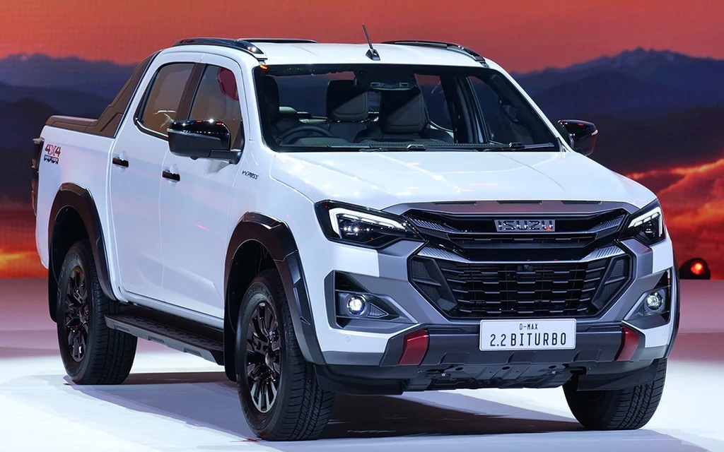White Isuzu pickup truck displayed against a dramatic sunset backdrop